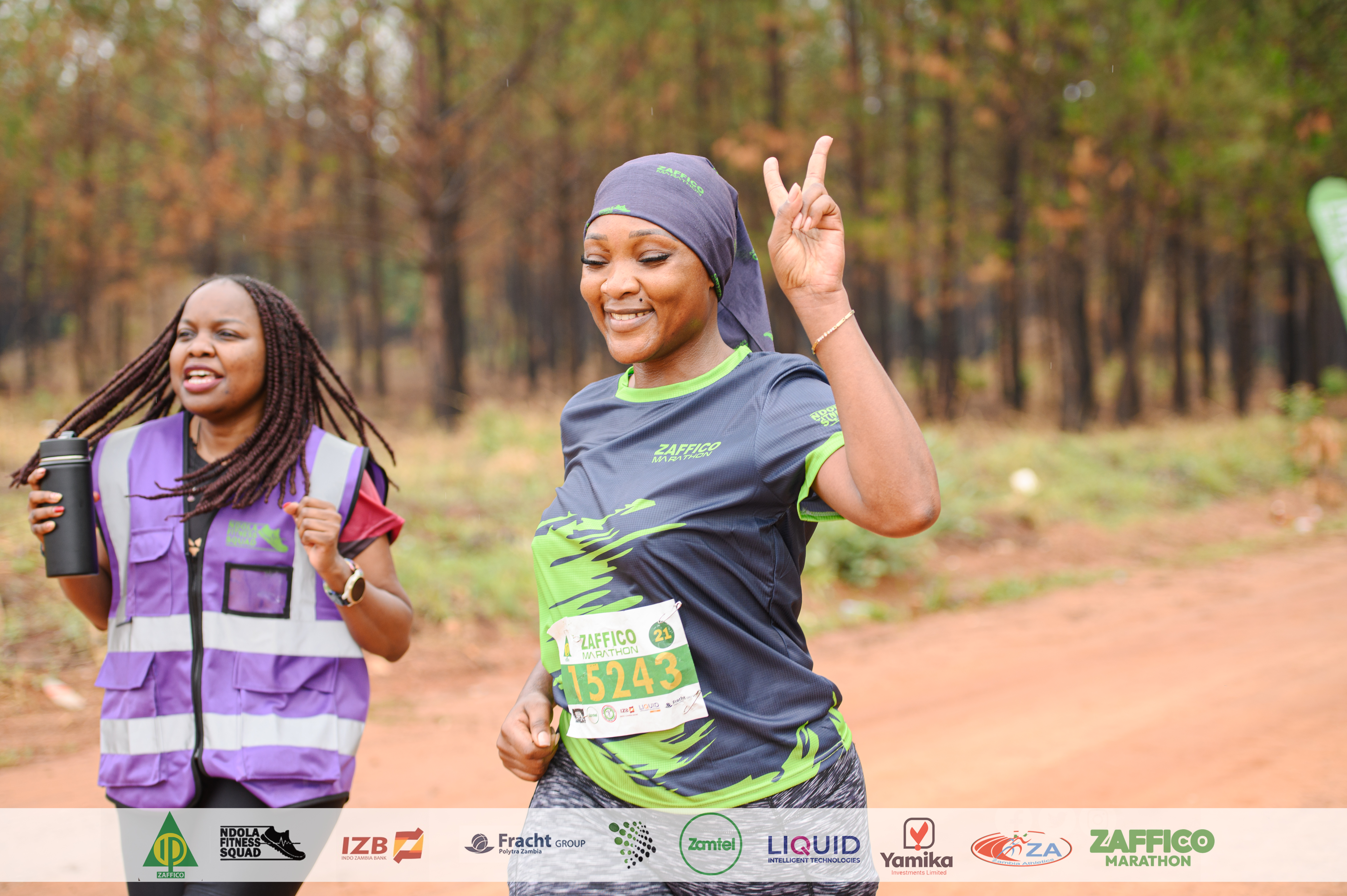 Marathon runners on a forest road at sunrise